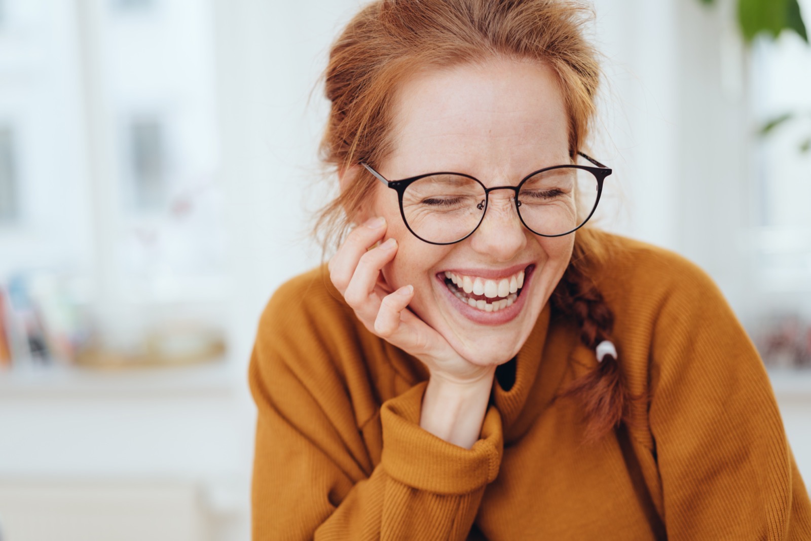 Woman laughing while wearing glasses